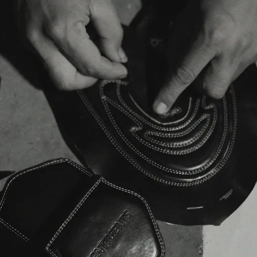 Sentiments craft step 5 — artisan hands assembling a finished pair.