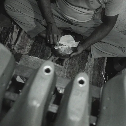 Sentiments craft step 6 — artisan hands assembling a finished pair.